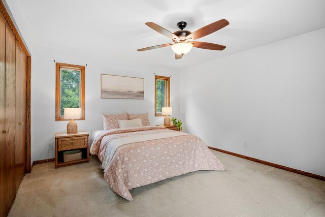 13326 Mallard Dr SE, Becker Twp, MN 55308 - bedroom featuring light carpet, a closet, and ceiling fan