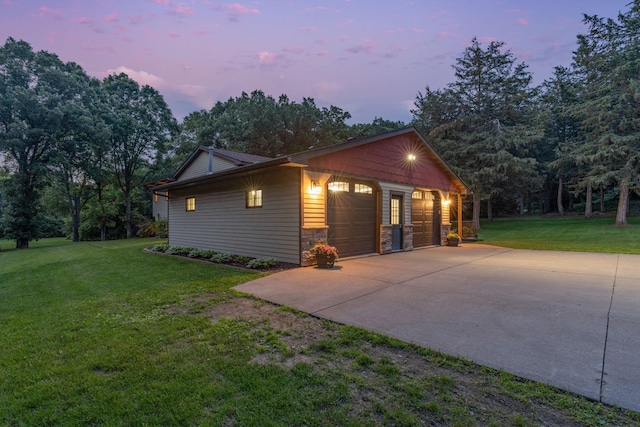13326 Mallard Dr SE, Becker Twp, MN 55308 - property exterior at dusk with stone siding, a lawn, and a garage