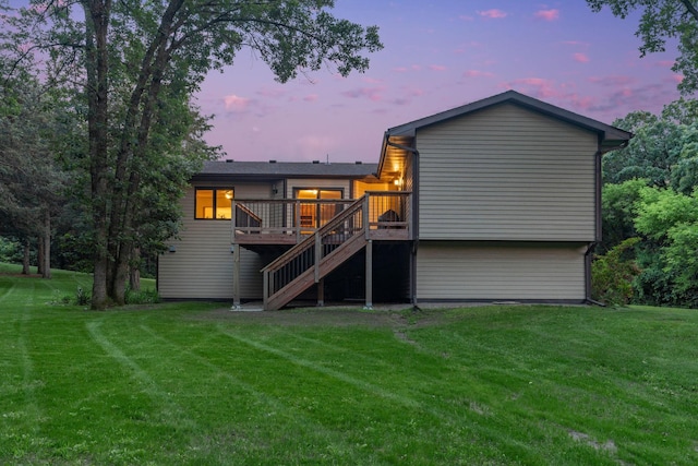 13326 Mallard Dr SE, Becker Twp, MN 55308 - back of house at dusk with stairs, a wooden deck, and a yard