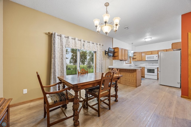 1403 2nd Ave NE, Barnesville, MN 56514 - dining room with a chandelier and light wood finished floors