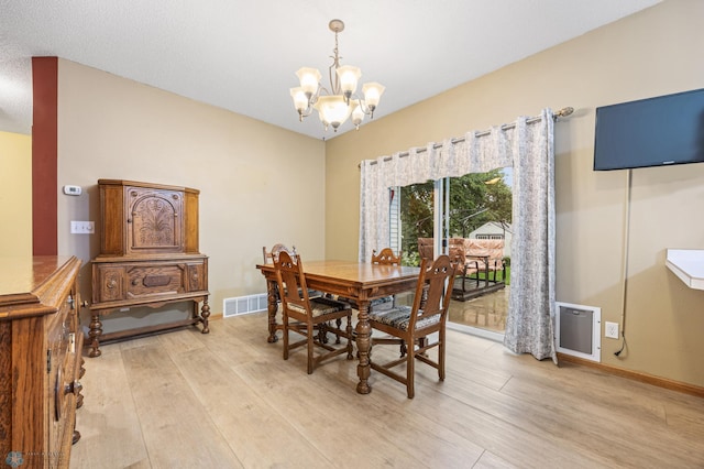 1403 2nd Ave NE, Barnesville, MN 56514 - dining space with light wood-style floors and a chandelier