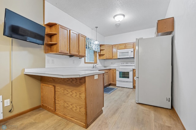 1403 2nd Ave NE, Barnesville, MN 56514 - kitchen with white appliances, open shelves, a peninsula, light wood-type flooring, and a textured ceiling