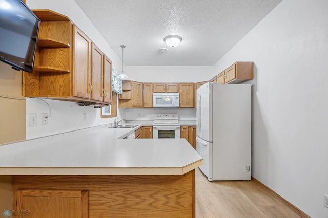 1403 2nd Ave NE, Barnesville, MN 56514 - kitchen with white appliances, open shelves, a peninsula, light countertops, and a textured ceiling