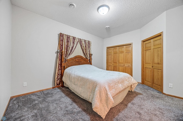 1403 2nd Ave NE, Barnesville, MN 56514 - carpeted bedroom featuring a textured ceiling and two closets