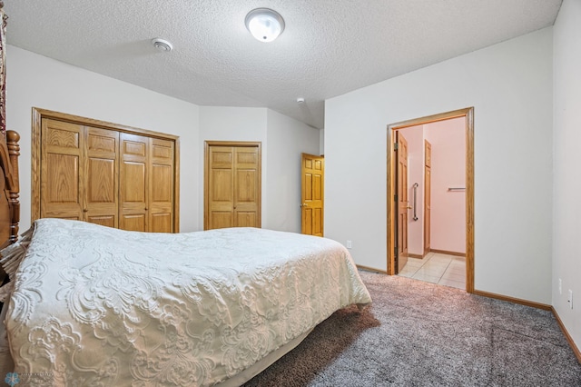1403 2nd Ave NE, Barnesville, MN 56514 - bedroom featuring light colored carpet, a textured ceiling, and ensuite bath