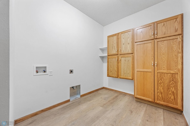 1403 2nd Ave NE, Barnesville, MN 56514 - washroom with cabinet space, hookup for an electric dryer, light wood finished floors, and washer hookup