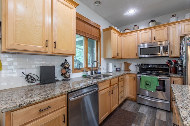 406 13th Ave NW, Kasson, MN 55944 - kitchen with stainless steel appliances, a textured ceiling, dark wood finished floors, light brown cabinetry, and light stone countertops