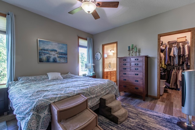 406 13th Ave NW, Kasson, MN 55944 - bedroom with light wood finished floors, a walk in closet, ensuite bath, and a ceiling fan