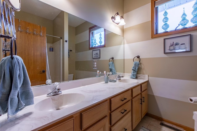 406 13th Ave NW, Kasson, MN 55944 - full bathroom with tile patterned floors, double vanity, a shower, and healthy amount of natural light