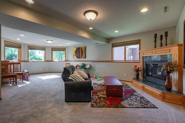 406 13th Ave NW, Kasson, MN 55944 - carpeted living area featuring a tile fireplace, recessed lighting, and a textured ceiling