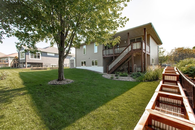 406 13th Ave NW, Kasson, MN 55944 - back of property featuring stairs, a yard, a storage shed, and a deck