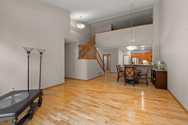 4543 Bloomberg Cir, Inver Grove Heights, MN 55076 - dining space featuring high vaulted ceiling, light wood-style flooring, and stairway