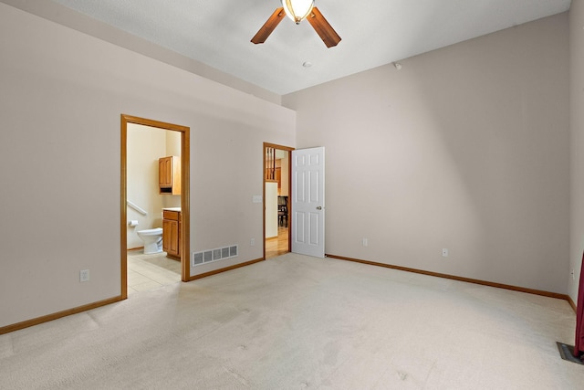 4543 Bloomberg Cir, Inver Grove Heights, MN 55076 - unfurnished bedroom with freestanding refrigerator, light carpet, connected bathroom, and ceiling fan