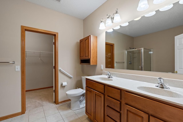 4543 Bloomberg Cir, Inver Grove Heights, MN 55076 - full bath with a stall shower, double vanity, a walk in closet, tile patterned flooring, and a textured ceiling