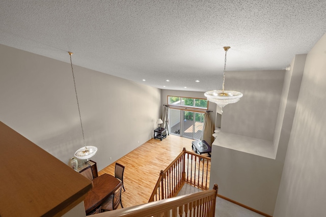 4543 Bloomberg Cir, Inver Grove Heights, MN 55076 - stairway with wood finished floors, a textured ceiling, recessed lighting, and a chandelier