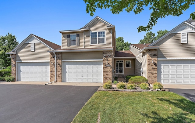 4543 Bloomberg Cir, Inver Grove Heights, MN 55076 - traditional home featuring brick siding, a front lawn, and asphalt driveway
