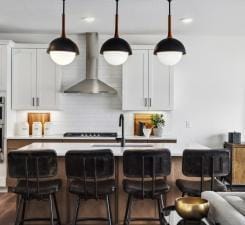 14560 106th Pl N, Maple Grove, MN 55369 - kitchen featuring wall chimney exhaust hood, light countertops, decorative backsplash, hanging light fixtures, and recessed lighting