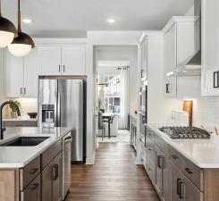 14560 106th Pl N, Maple Grove, MN 55369 - kitchen featuring appliances with stainless steel finishes, dark wood-style floors, light countertops, white cabinets, and pendant lighting