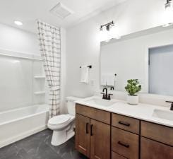 14560 106th Pl N, Maple Grove, MN 55369 - bathroom with double vanity and shower / tub combo with curtain