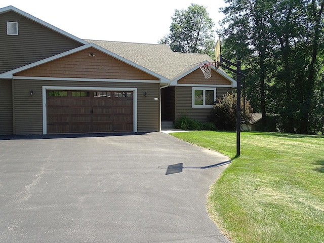 224 Country Ln, Durand, WI 54736 - view of front of home featuring driveway, a garage, a front lawn, and roof with shingles