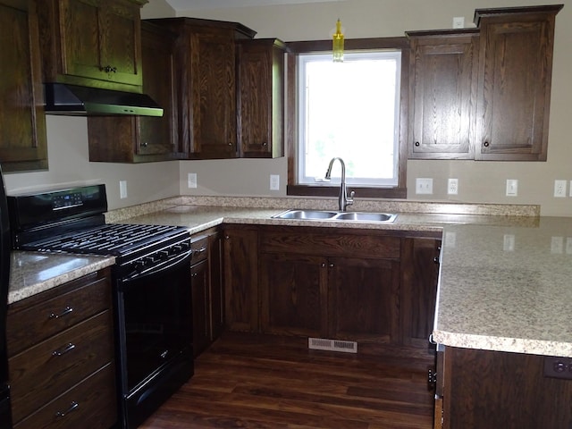 224 Country Ln, Durand, WI 54736 - kitchen featuring black gas range oven, exhaust hood, dark wood finished floors, and dark brown cabinetry