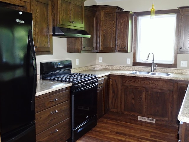 224 Country Ln, Durand, WI 54736 - kitchen featuring black appliances, under cabinet range hood, dark wood-type flooring, light countertops, and dark brown cabinets