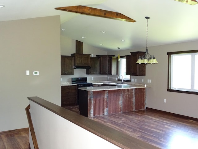 224 Country Ln, Durand, WI 54736 - kitchen with lofted ceiling, black gas stove, dark brown cabinets, dark wood finished floors, and light countertops