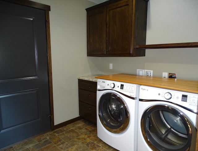 224 Country Ln, Durand, WI 54736 - washroom featuring washing machine and dryer, cabinet space, and dark stone finish flooring