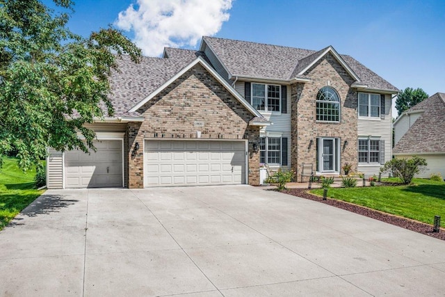 10695 184th Ave NW, Elk River, MN 55330 - view of front facade featuring driveway, an attached garage, brick siding, a front yard, and roof with shingles