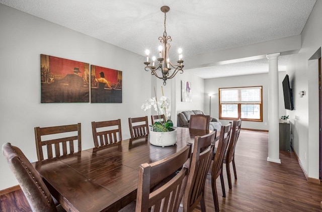10695 184th Ave NW, Elk River, MN 55330 - dining room featuring wood finished floors, a textured ceiling, a chandelier, and ornate columns