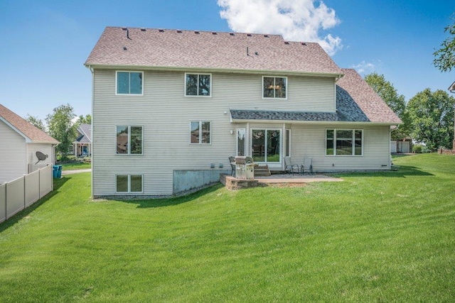 10695 184th Ave NW, Elk River, MN 55330 - rear view of property featuring a lawn, a patio, and a shingled roof