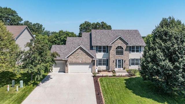 10695 184th Ave NW, Elk River, MN 55330 - view of front facade with concrete driveway, a garage, a front yard, and brick siding