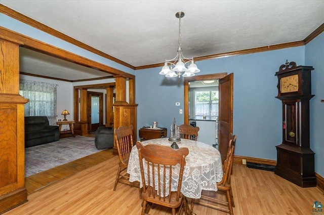 2014 5th St, Superior, WI 54880 - dining area featuring light wood-style flooring, a chandelier, and crown molding