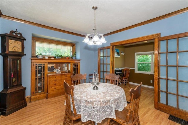 2014 5th St, Superior, WI 54880 - dining area featuring a chandelier, wood finished floors, ornamental molding, and french doors
