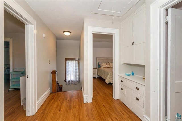 2014 5th St, Superior, WI 54880 - hall with attic access, light wood-style flooring, and an upstairs landing