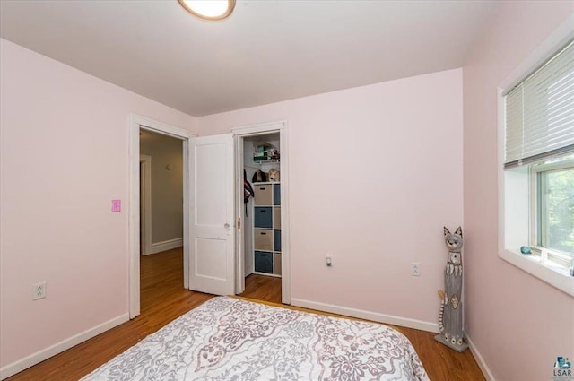 2014 5th St, Superior, WI 54880 - bedroom featuring wood finished floors, a walk in closet, and a closet