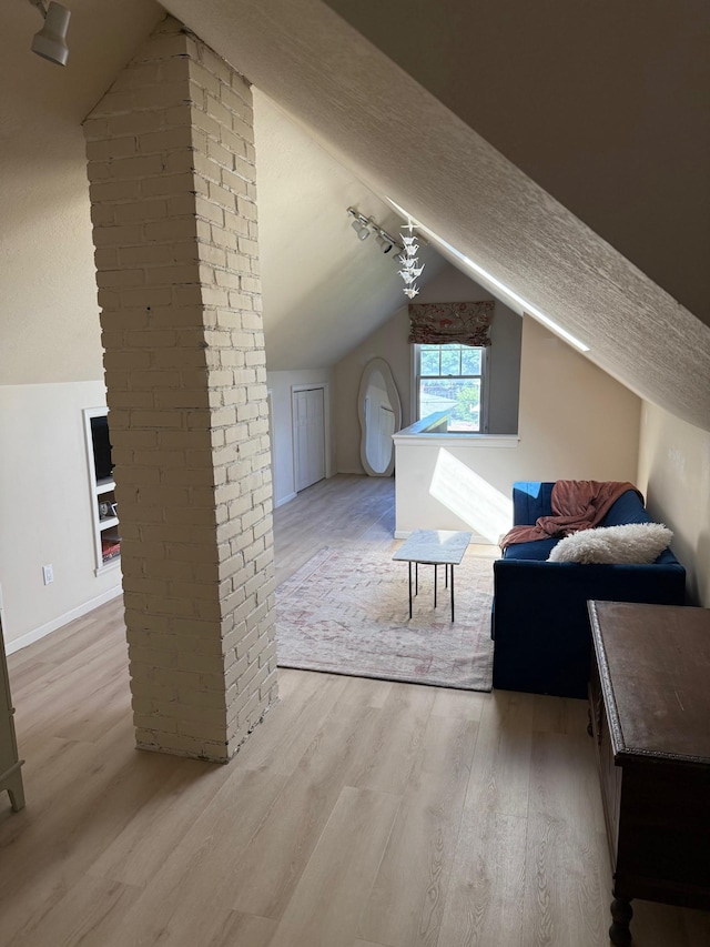 2639 Arthur St NE, Minneapolis, MN 55418 - additional living space featuring lofted ceiling, light wood-style floors, and a textured ceiling