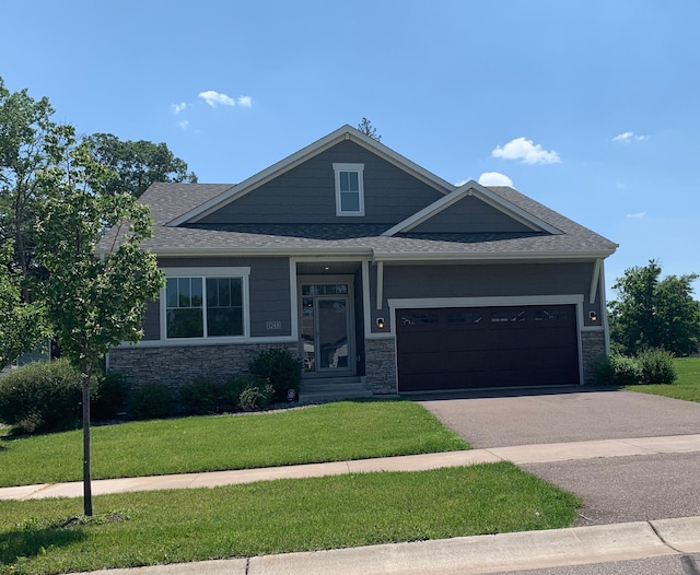 1248 100th Ave NW, Coon Rapids, MN 55433 - view of front of home with a front lawn, driveway, a garage, and stone siding