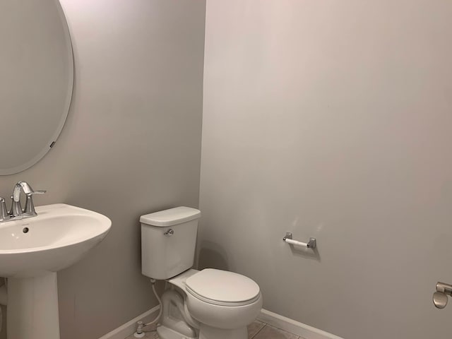1248 100th Ave NW, Coon Rapids, MN 55433 - half bath featuring toilet and tile patterned flooring