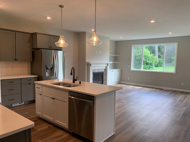 1248 100th Ave NW, Coon Rapids, MN 55433 - kitchen with appliances with stainless steel finishes, light countertops, dark wood finished floors, a fireplace, and recessed lighting
