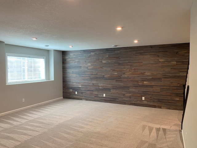 1248 100th Ave NW, Coon Rapids, MN 55433 - carpeted spare room with recessed lighting, wooden walls, an accent wall, and a textured ceiling