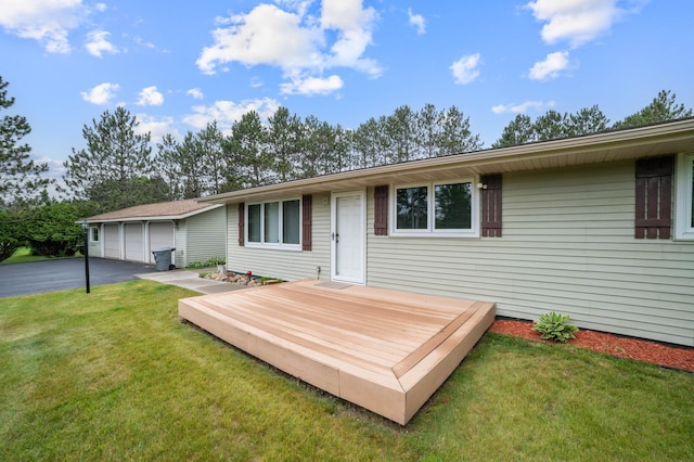 3661 Riley Rd, Rice Lake Twp, MN 55803 - rear view of property with a wooden deck, a yard, and a garage