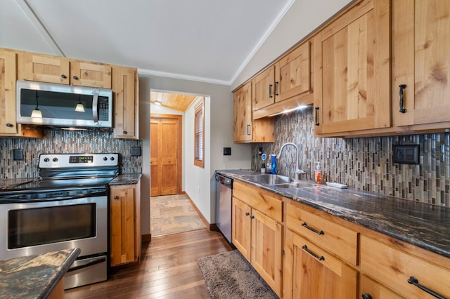 3661 Riley Rd, Rice Lake Twp, MN 55803 - kitchen with vaulted ceiling, stainless steel appliances, ornamental molding, dark wood finished floors, and decorative backsplash