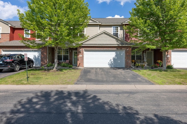 9605 Scott Cir N, Brooklyn Park, MN 55443 - view of front of property with driveway, a front yard, an attached garage, and brick siding