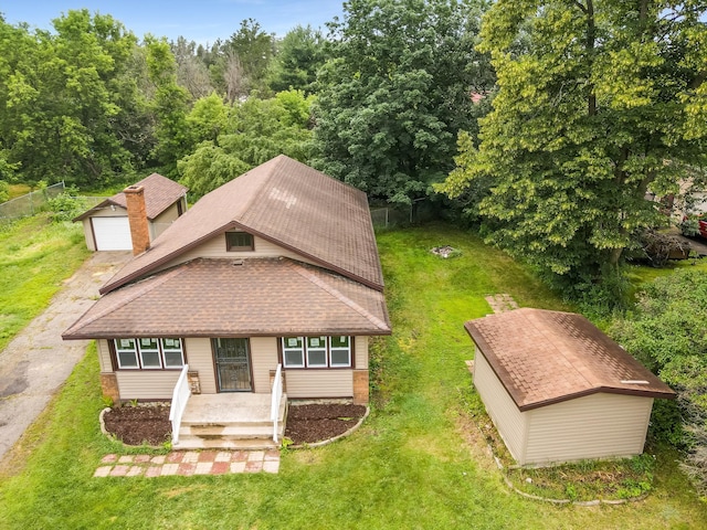 30867 Rasmussen Rd, Pequot Lakes, MN 56472 - view of front of property with an outdoor structure, a front yard, a shingled roof, a garage, and driveway