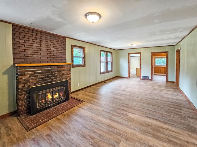 30867 Rasmussen Rd, Pequot Lakes, MN 56472 - unfurnished living room with wood finished floors and a brick fireplace