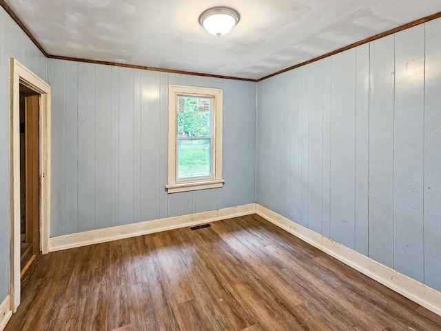 30867 Rasmussen Rd, Pequot Lakes, MN 56472 - spare room featuring dark wood-style floors, ornamental molding, and wooden walls