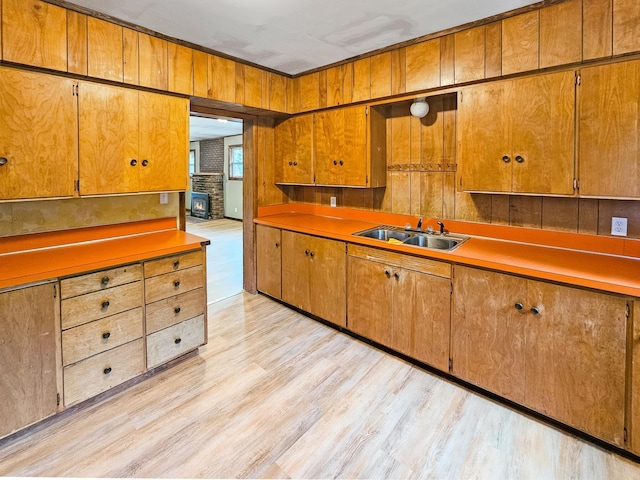 30867 Rasmussen Rd, Pequot Lakes, MN 56472 - kitchen featuring light wood-style flooring, light countertops, and brown cabinetry