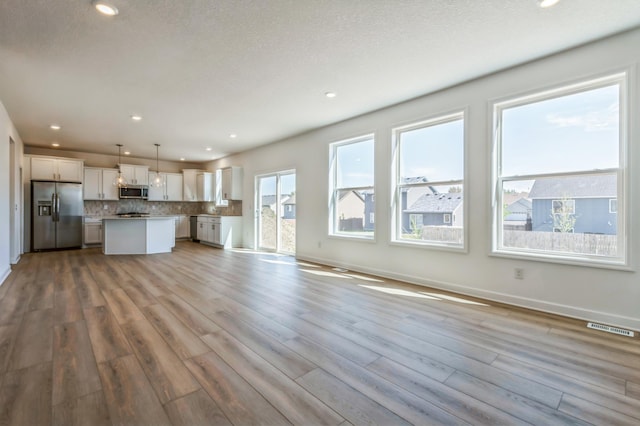 2550 Downing Ave, Shakopee, MN 55379 - unfurnished living room with wood finished floors and recessed lighting