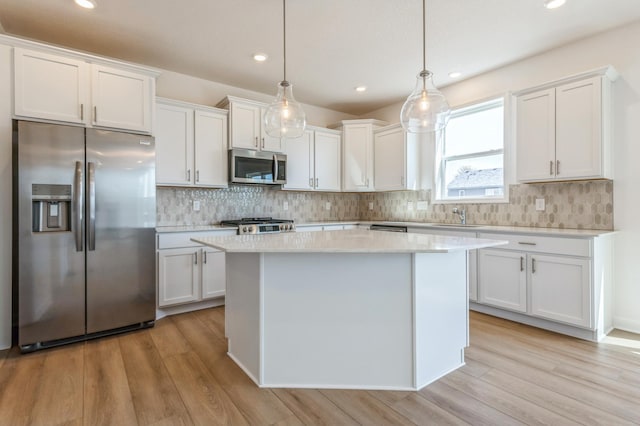 2550 Downing Ave, Shakopee, MN 55379 - kitchen featuring stainless steel appliances, white cabinetry, a center island, light wood-style flooring, and recessed lighting
